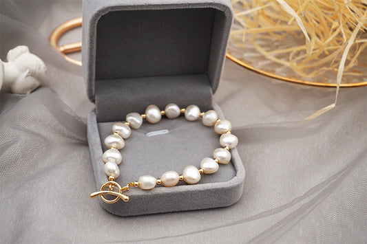 PULSERA DE PERLAS CON APLIQUES DE ORO 18K